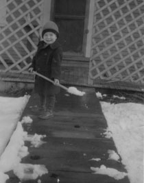 Jerre as a child, shoveling snow